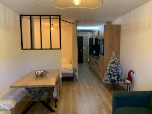 a living room with a christmas tree in a room at Studio cosy proche du centre in Les Gets