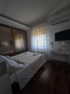 a bedroom with a large bed and a window at Narni Come a casa dei nonni in Fiaiola