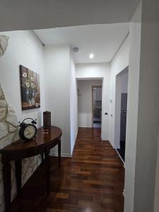 a living room with a table and a hallway at Narni Come a casa dei nonni in Fiaiola