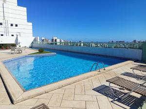 a swimming pool on top of a building at Bussines Flat Iguatemi in Salvador