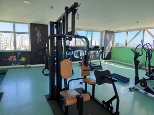a gym with several tread machines in a room at Bussines Flat Iguatemi in Salvador