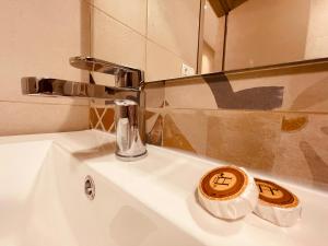 a bathroom sink with a chrome faucet and a mirror at ZyonFamily in Ouarzazate +30 photos