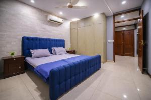 a large blue bed in a room with at Private 2BD Apartment Opposite Dha Phase 8 in Lahore