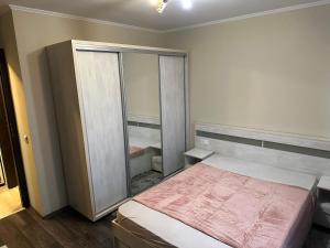 a bedroom with a bed and a large mirror at Republicii Central in Ploieşti