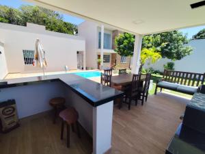 an outdoor kitchen and dining area with a table and chairs at Casa em São Mateus - Guriri in São Mateus