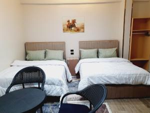 a room with two beds and two chairs in it at Andy Guest House Pyramids View in Cairo +71 photos