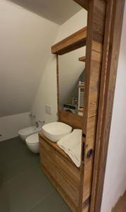 a bathroom with two toilets and a sink at Sky nest - Matterhorn in Breuil-Cervinia +20 photos