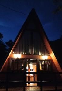 a house with a large window at night at Refúgio Bocaina in Bocaina do Sul