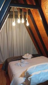 a bed in a tent with towels on it at Refúgio Bocaina in Bocaina do Sul +14 photos