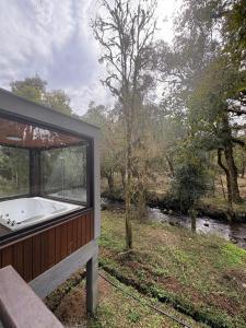 a house with a bath tub in a field at Refúgio Bocaina in Bocaina do Sul