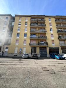 a large building with cars parked in front of it at Piazza Vida 12 Palace in Cremona +40 photos
