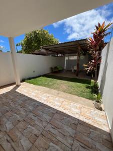 a patio of a house with a pavilion at Suíte Peroba em Maragogi in Maragogi