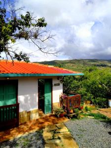 a house with an orange roof and a porch at Villa Paula in Barichara