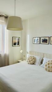 a white bedroom with a white bed with two pillows at Albergo Al Castello in Gavi +60 photos