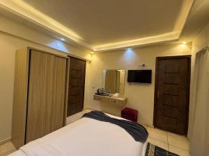 a bedroom with a bed and a television in it at Bedouin Camp pyramids view INN in Cairo