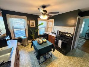 a kitchen with a stove and a table in it at Gallows Hill Guest House in Salem