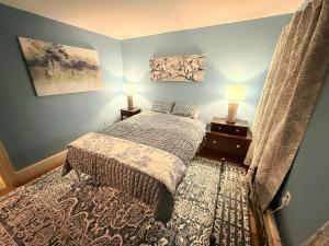 a bedroom with a bed and two lamps in it at Gallows Hill Guest House in Salem