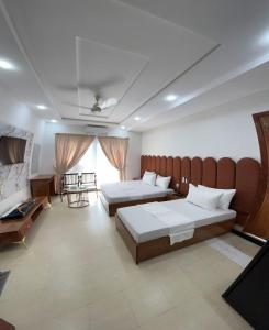 En eller flere senge i et værelse på The Guest House Islamabad