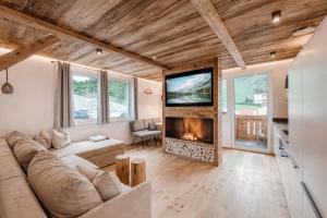 a living room with a couch and a fireplace at OLDWOOD CHALET - AlpenLuxus Collection in Fügen