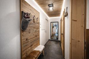 a hallway with a wooden wall and a bench at OLDWOOD CHALET - AlpenLuxus Collection in Fügen +24 photos