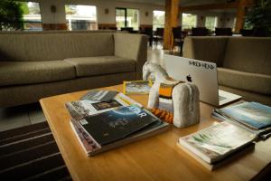 a table with a laptop and books on it at Hotel HD Natales in Puerto Natales