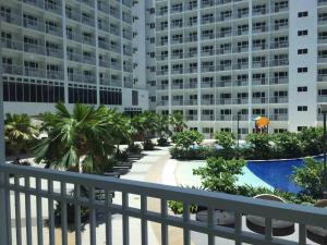 a balcony view of a resort with a pool and buildings at Haven's Suites a place like home in Manila