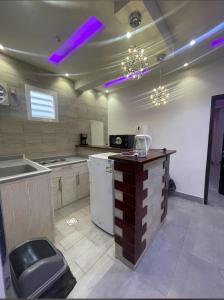 a large kitchen with purple lights on the ceiling at شاليه ريفالا الفاخر in Abha