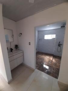 a white bathroom with a sink and a mirror at Supernova Glamping in Macanal