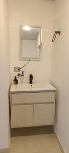 a bathroom with a white sink and a mirror at Supernova Glamping in Macanal +1 photo