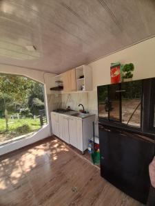 an interior view of an rv with a kitchen at Supernova Glamping in Macanal