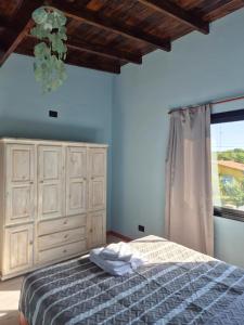 a bedroom with a bed and a large window at Mardel Chapla in Colonia Chapadmalal