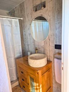 a bathroom with a sink and a mirror at Mardel Chapla in Colonia Chapadmalal +12 photos