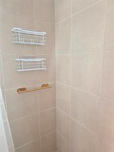 a bathroom with a shower with a tiled wall at Mardel Chapla in Colonia Chapadmalal