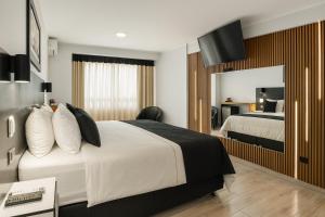 a hotel room with a bed and a mirror at City Tower Hotel in Lima