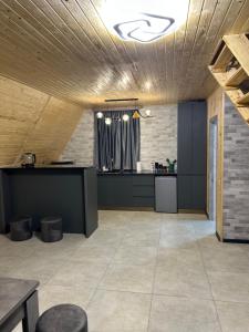 a large room with a kitchen and a table at Cottage Godzia in Sadgeri