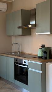 a kitchen with a sink and a stove top oven at Turin Bicerin Green in Turin +22 photos