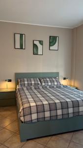 a bedroom with a bed with three pictures on the wall at Turin Bicerin Green in Turin
