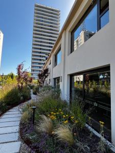 a building with a garden in front of it at Sea Garden Tower 2 in Punta del Este