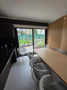 a dining room with chairs and a table and a window at Sea Garden Tower 2 in Punta del Este +45 photos