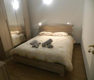 a bedroom with a bed with two stuffed animals on it at JeD SWEET DREAMS in LʼAquila