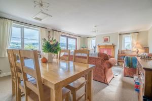 a living room with a table and a couch at Llwyn-Y-Coed-Isaf in Llanbedr-y-cennin