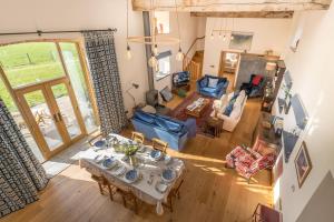 an overhead view of a living room with a table and chairs at The-Longbarn in Ruthin