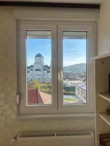 a window with a view of a building at Hram View Apartment, Valjevo Center in Valjevo