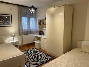 a small bedroom with two beds and a closet at Hram View Apartment, Valjevo Center in Valjevo