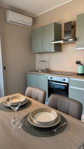 a dining room table with chairs and a kitchen at Turin Bicerin Green in Turin