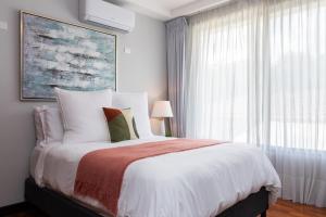 a bedroom with a large bed and a window at Corteza 2BD Gated AC Quiet Terrace Pools in Jacó +43 photos