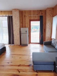 a living room with a couch and a refrigerator at บ้านพัก กามู Gamoo homestay in Chom Thong +66 photos