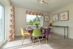a dining room with a table and chairs at Hendre-Llangwm in Llangwm +22 photos