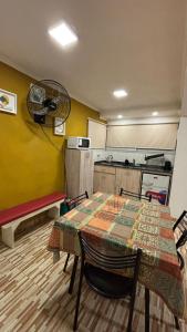 een kamer met een tafel en een keuken met een ventilator bij Cabaña Concepcion del Valle in Salsacate