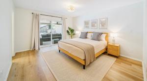 a white bedroom with a bed and a window at Heart of Tulsa, pool, game room, Sleeps 8 in Tulsa +23 photos